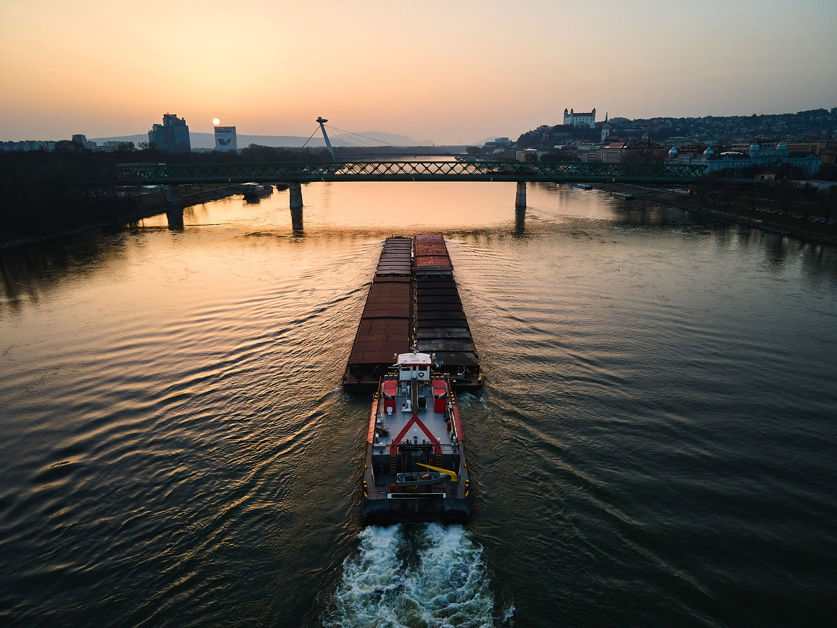 aerial view of cargo boat and barge on river