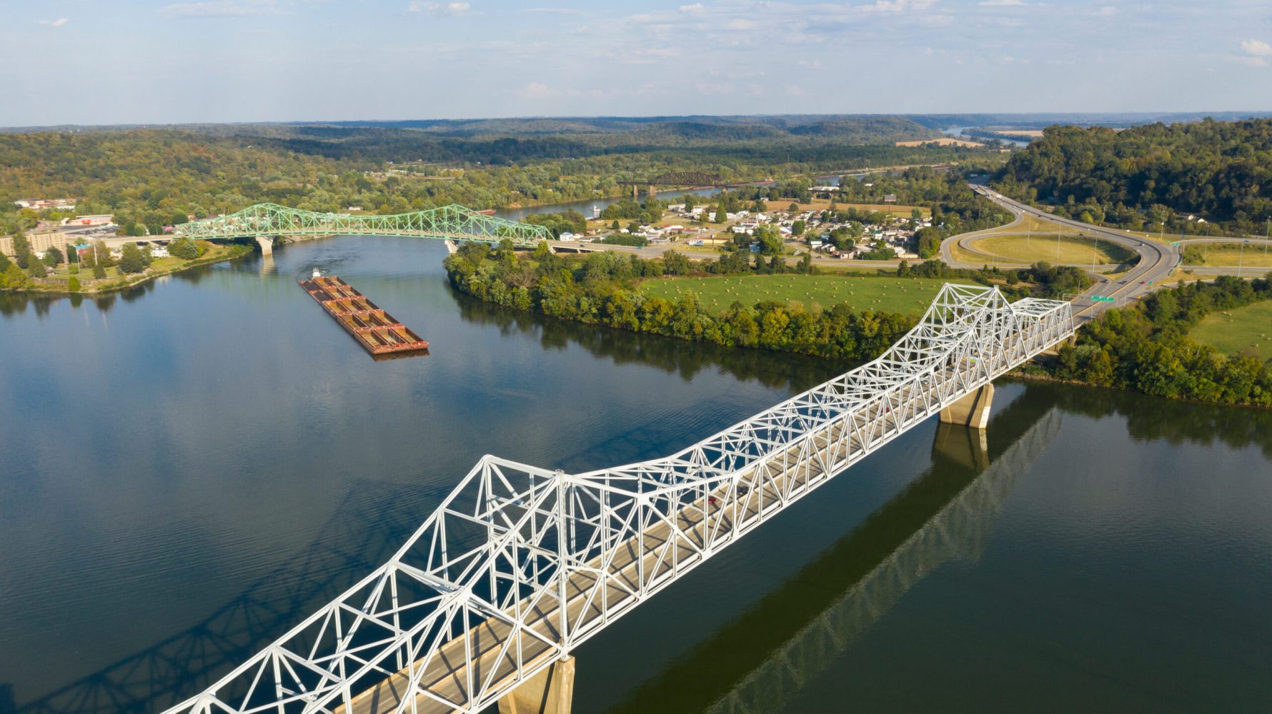 a river tugboat pushes barge contents down the Ohio River