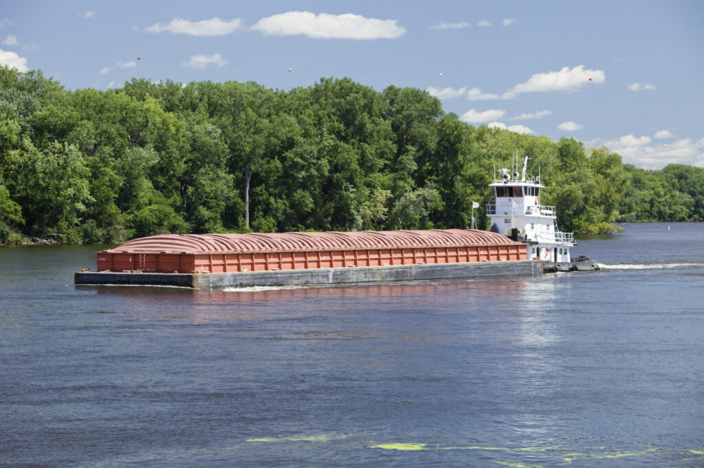 a barge being towed down the river