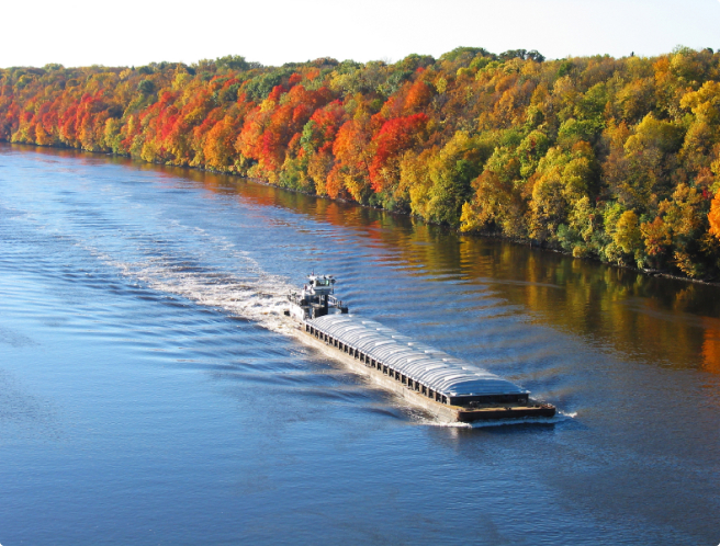barge moving on a river using BargeOps fleet management software
