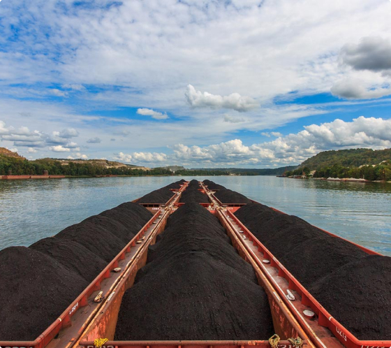 barge carrying cargo on a river using transportation management software